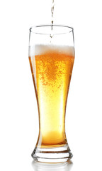 Pouring beer into glass isolated on white