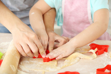 Obraz na płótnie Canvas Little girl preparing cookies in kitchen at home