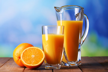 Glass and pitcher of orange juice