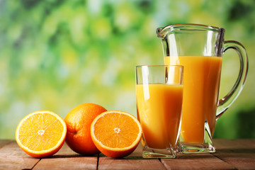 Glass and pitcher of orange juice