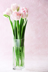 Beautiful spring flowers on pink background