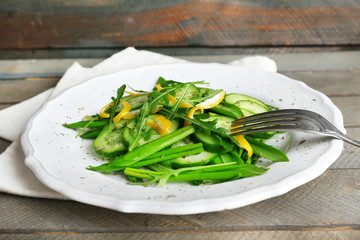 Green salad with cucumber, arugula and lemon peel
