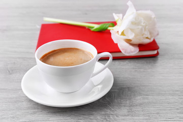 Beautiful tulip with diary and cup of coffee