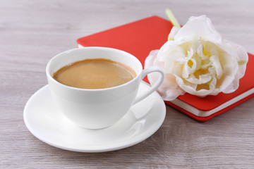 Beautiful tulip with diary and cup of coffee