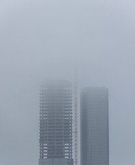 Two big skyscrapers surrounded by smog and pollution