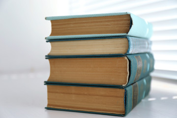 Books on white windowsill, close up