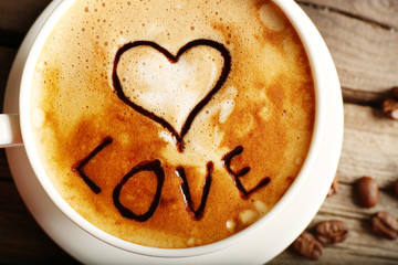 Cup of latte art coffee with grains, closeup