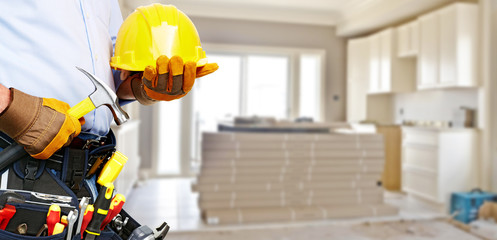 Builder handyman with construction tools.