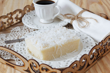 Obraz na płótnie Canvas Brazilian dessert sweet couscous pudding coconut, cup of coffee