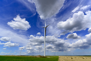 windmill farm turbines with beautiful grey white clouds and
