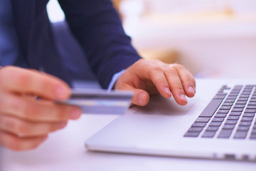 Fototapeta premium Businessman using his credit card for an online transaction