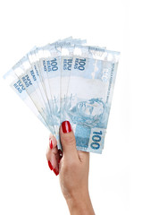 Woman's hand and Brazilian money