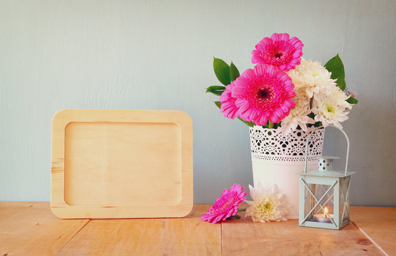 Summer bouquet of flowers on the wooden table and wooden board w