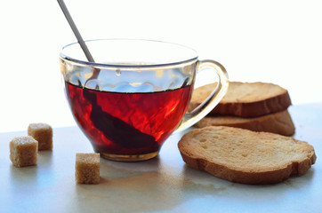 Baked baguette slices, tea and sugar