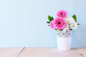 summer bouquet of flowers on the wooden table with mint backgrou