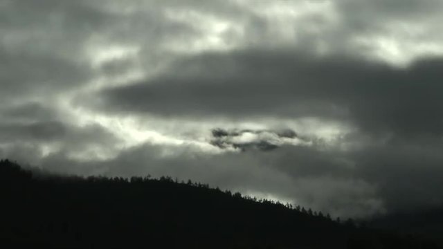 Time lapse video of clouds rolling by the country hillside