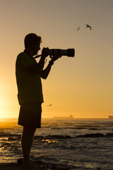 Photographer ready to photograph birds at sunset