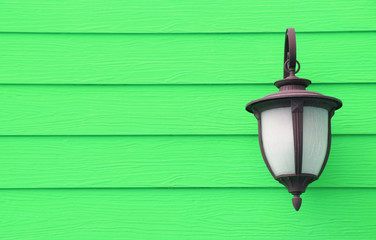 Vintage lamp hanging on wooden wall