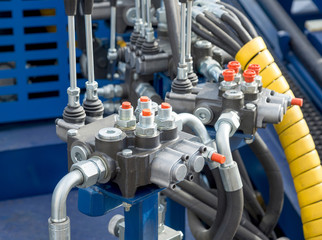 Hydraulic tubes, fittings and levers on control panel