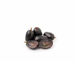 Black seedless grapes on white background