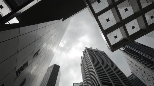 Time Lapse of clouds rolling by at office buildings in financial district