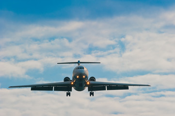plane on sky background with gear and flaps ready for planting