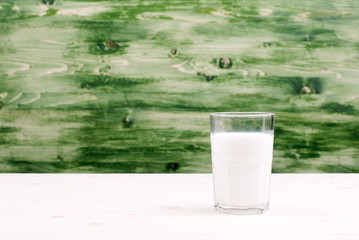 milk in a glass on the table side view