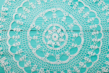 Lace pattern on blue wooden background