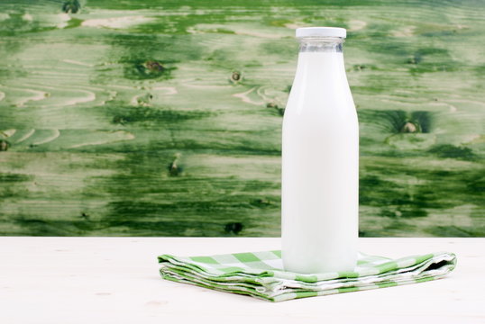 milk in a glass on the table side view