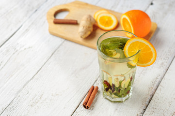 Herbal tea with orange and ginger in glass
