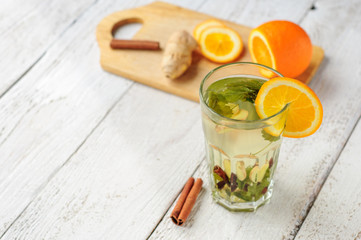 Fototapeta premium Herbal tea with orange and ginger in glass