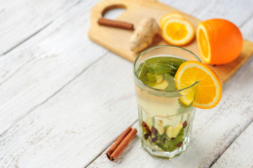 Herbal tea with orange and ginger in glass