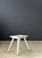 Small white wooden chair standing on the floor