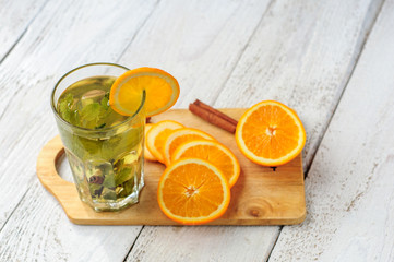 Herbal tea with orange and ginger in glass