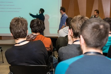 Conference hall with people.