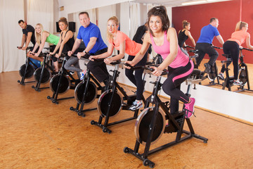 spinning - cycling group of fitness people