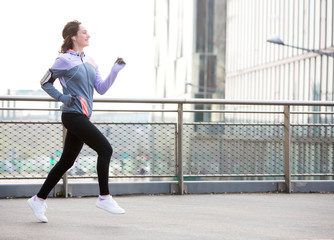 Young attractive woman running downtown