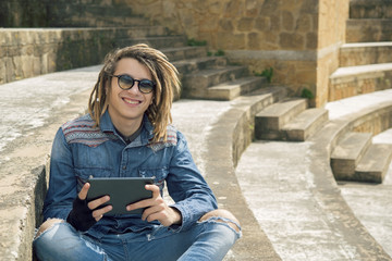handsome guy smiling with dreadlocks warm filter applied