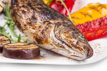Grilled fish with vegetables.