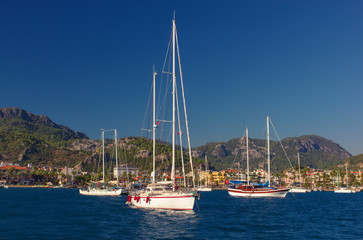 Fototapeta na wymiar White yachts on an anchor in harbor