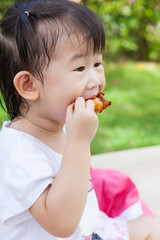 Closeup little asian (thai) girl enjoy eating her lunch