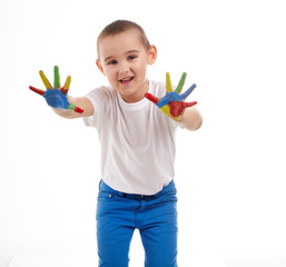 Five year old boy with hands painted in colorful paints ready fo