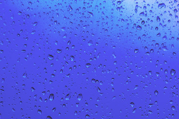 Blue water drops on the glass