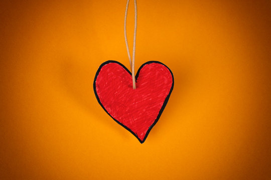 Red Paper Heart On A Yellow Background