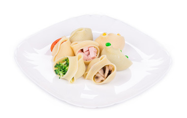 Pasta shells stuffed with vegetables and sausage.