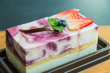Blue berry cheese cake on wooden plate