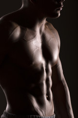 Fototapeta na wymiar muscular man body with black background