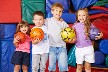 Gruppe Kinder mit Bällen in der Turnhalle