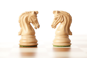  white chess knights standing next to each other