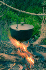 Boiling pot on the campfire on picnic.